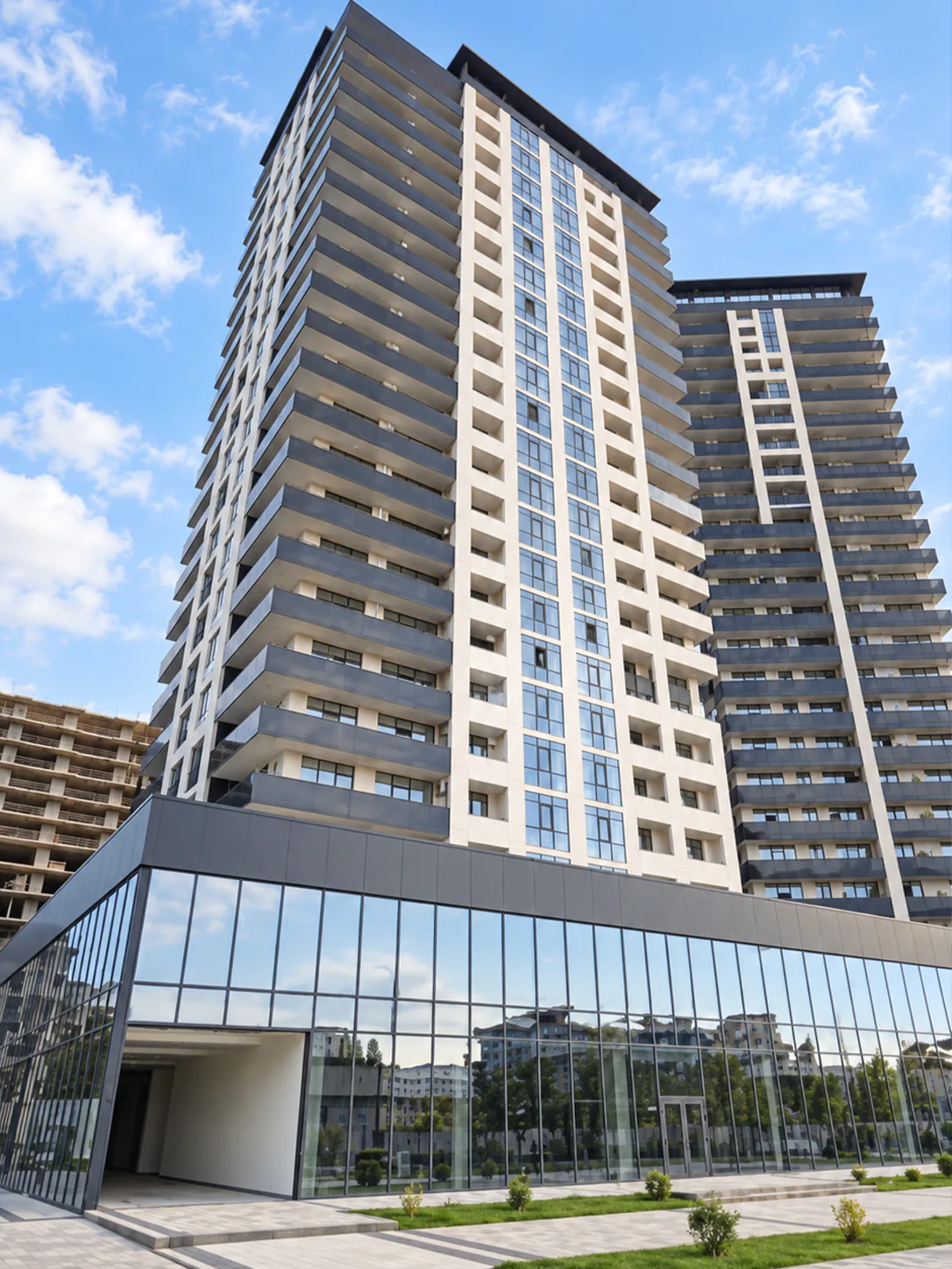Accent residential complex in Batumi with two high-rise towers and a glass-fronted commercial podium