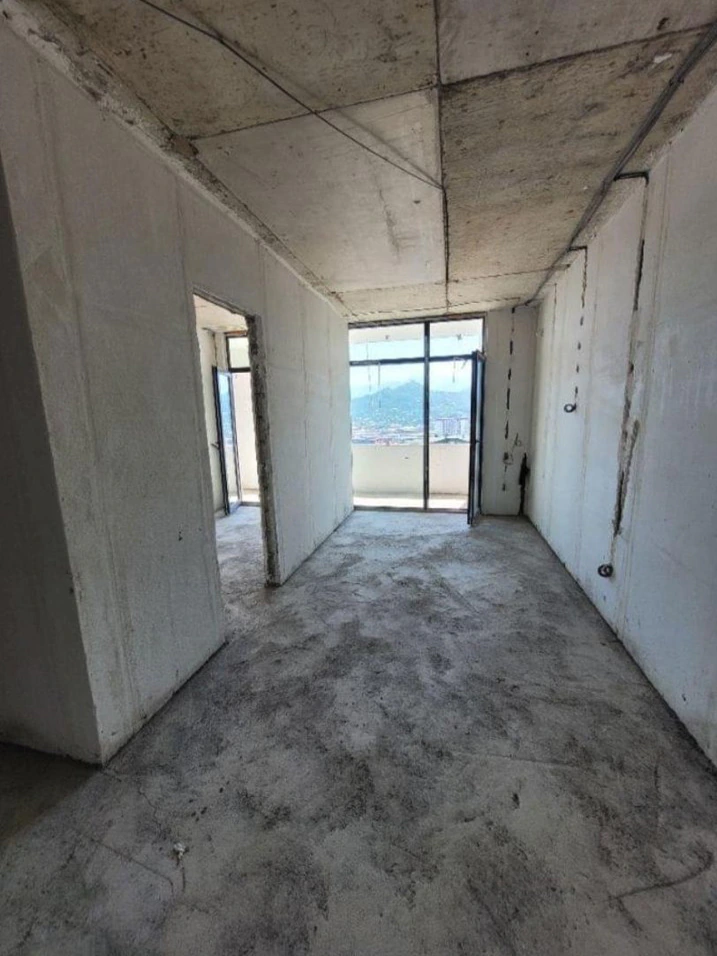 White-frame one-bedroom apartment in Accent Batumi with balcony glazing and mountain views