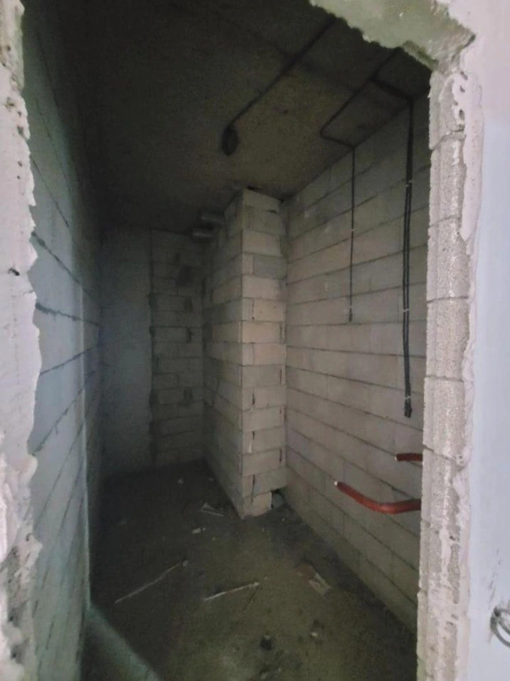Unfinished bathroom in an Accent apartment with plumbing and electrical connections in place