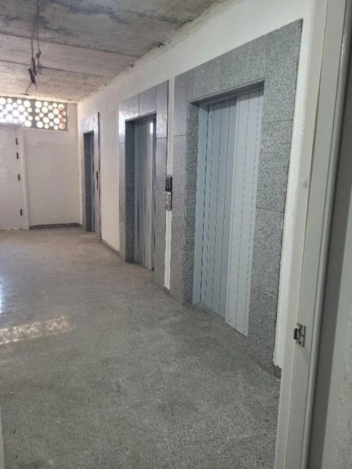 Three-elevator lobby inside the Accent residential complex in Batumi