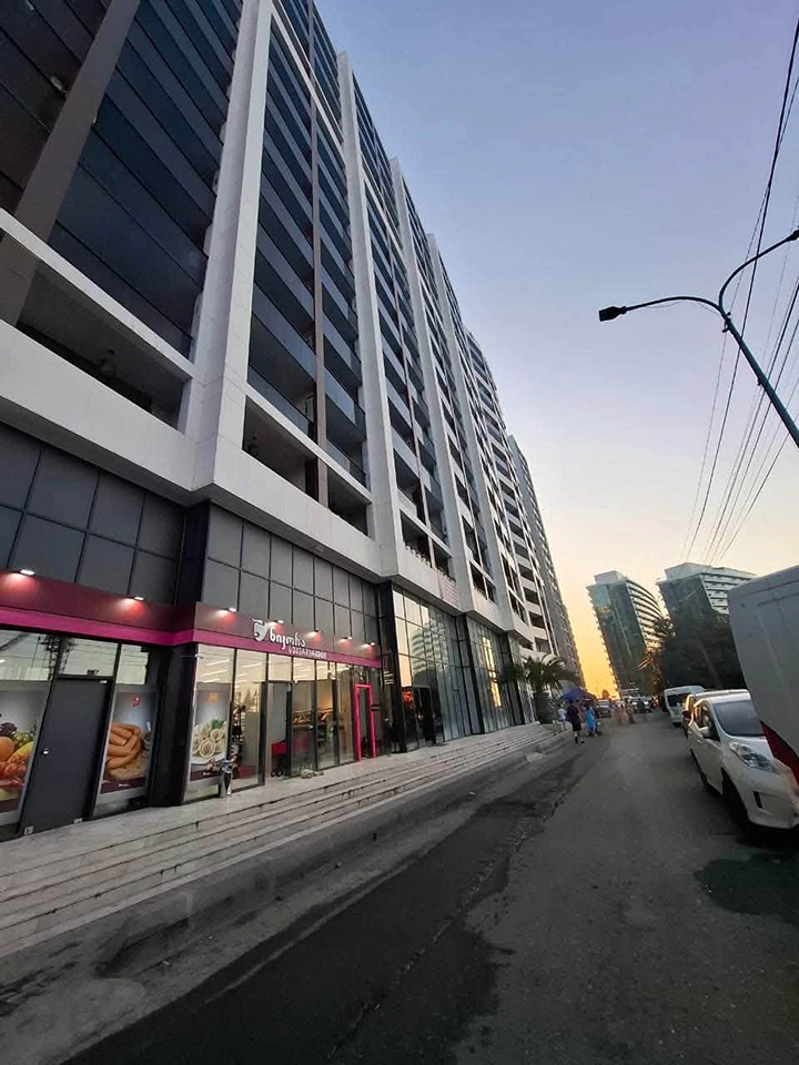 Front facade of Ande Tower 2 in Batumi, with balconies and ground-floor shops