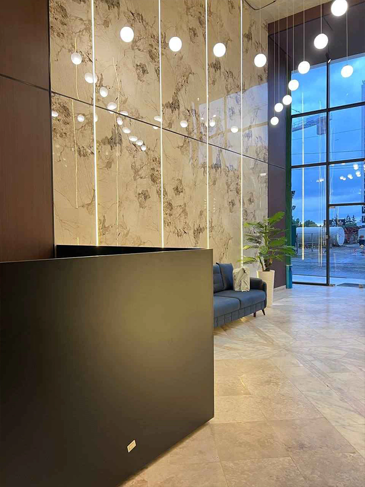 Ande Tower 2 entrance lobby with a reception desk, seating and pendant lighting