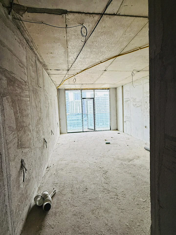 View from the entrance into the unfinished open-plan studio towards the balcony
