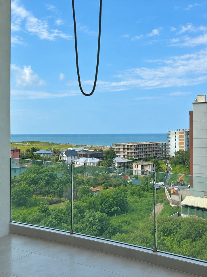 Side sea view from the apartment balcony in Optima Residence