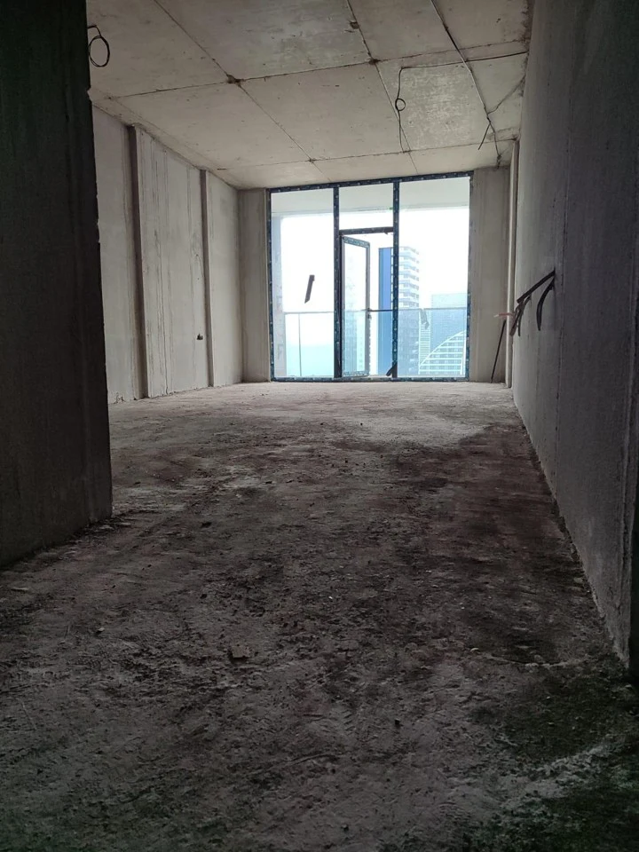 White-frame studio interior with floor-to-ceiling balcony windows