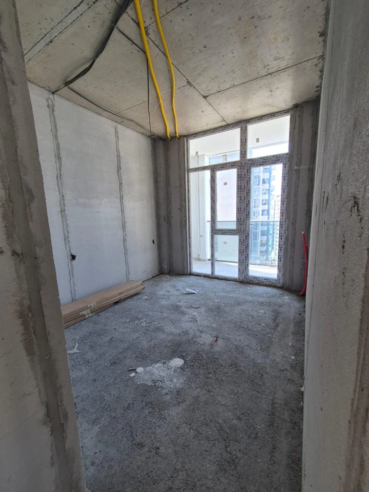 Unfinished bedroom with floor-to-ceiling balcony window