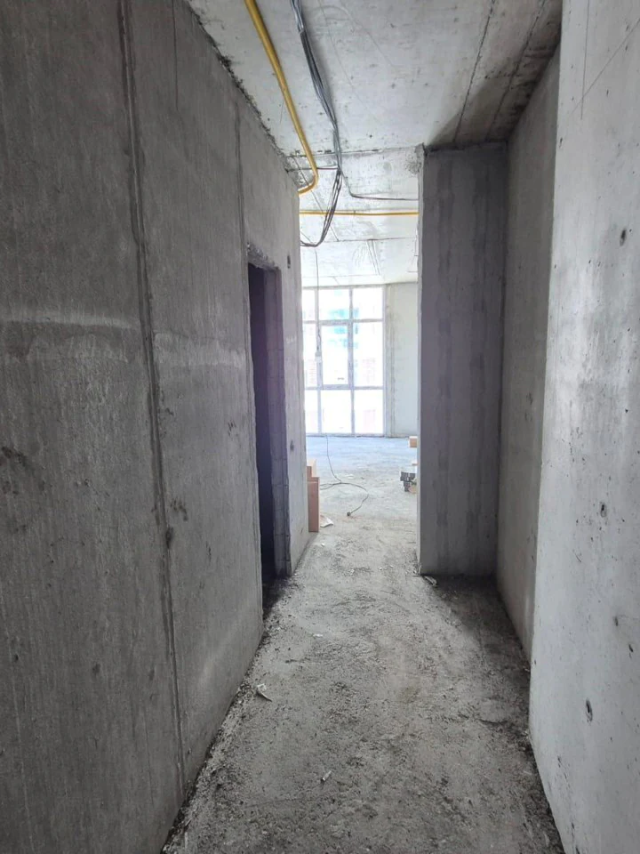 Unfinished apartment hallway with gas lines
