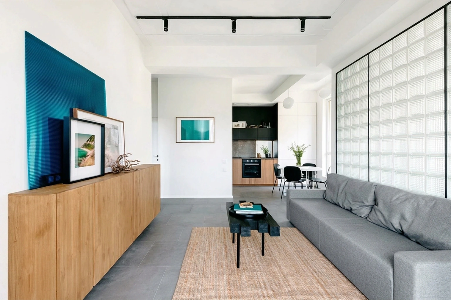 Renovated living room with glass-block partition and open kitchen