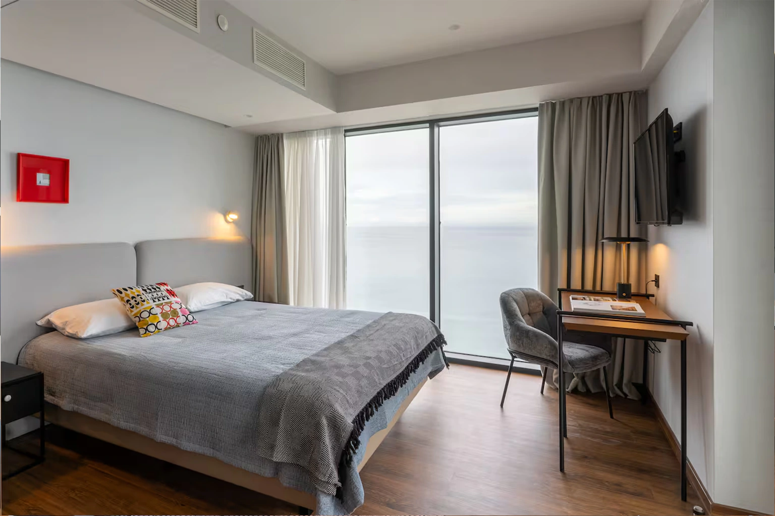 Bedroom with desk and panoramic sea view